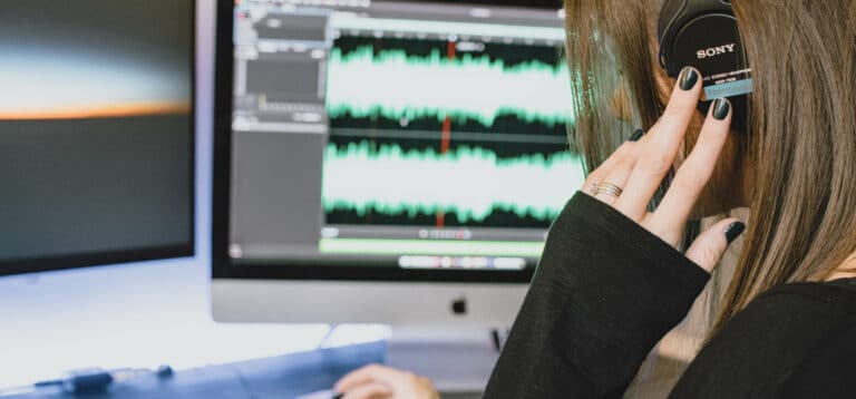 Woman listening and transcribing audio to text