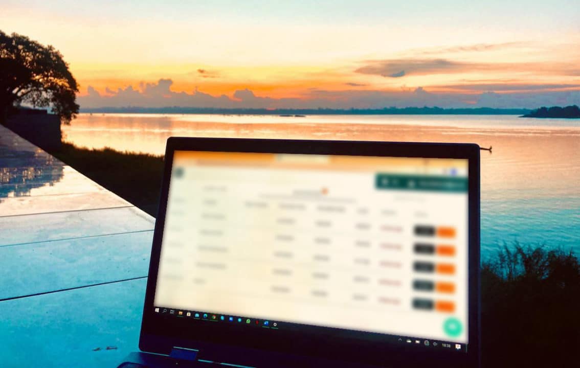 Sunset with a laptop in front, with transcriber tasks to be done.