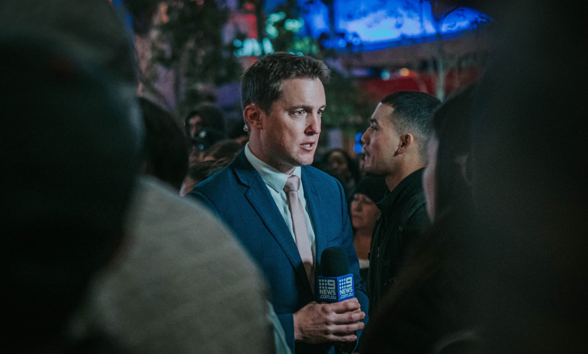 A broadcast television journalist in front of the camera during live speech