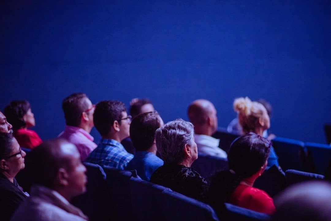 People sitting in cinema waiting for the show to start