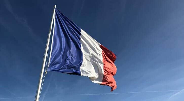 How to get French subtitles: Image of the French flag in front of a blue sky