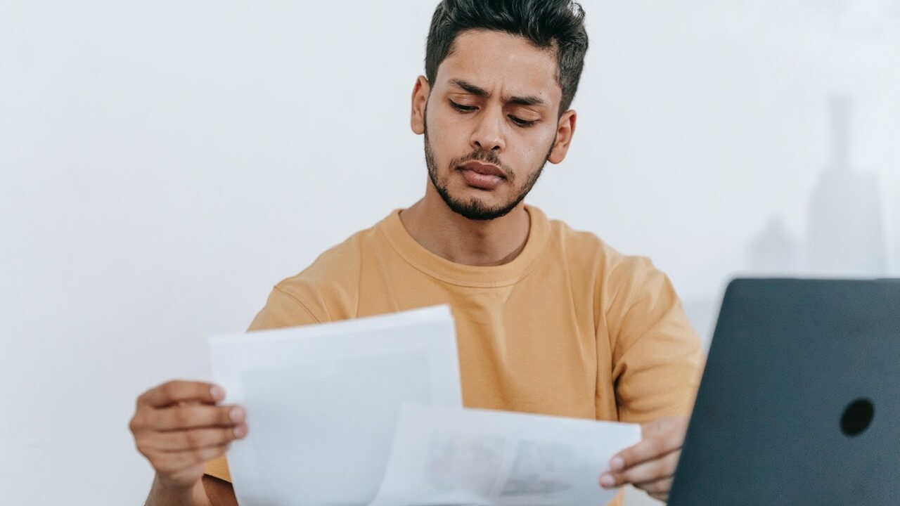 A person looking at a printed transcript