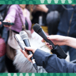 journalists holding out their microphones.